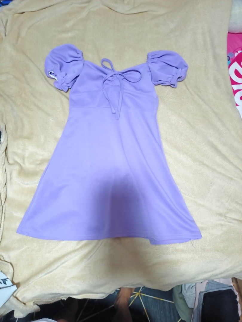 Purple Puff Sleeve Tie Front Mini Dress (Category: Dresses) located in Rizal. Submitted by declutterprod (Listing ID 1440802440, Image 2). Description: - Adorable purple mini dress - Features stylish puff sleeves - Flattering tie-front detail - Made from soft and stretchy fabric for comfort - Please note: there are a couple of small marks on the skirt area. Kindly check the photos for a closer look..