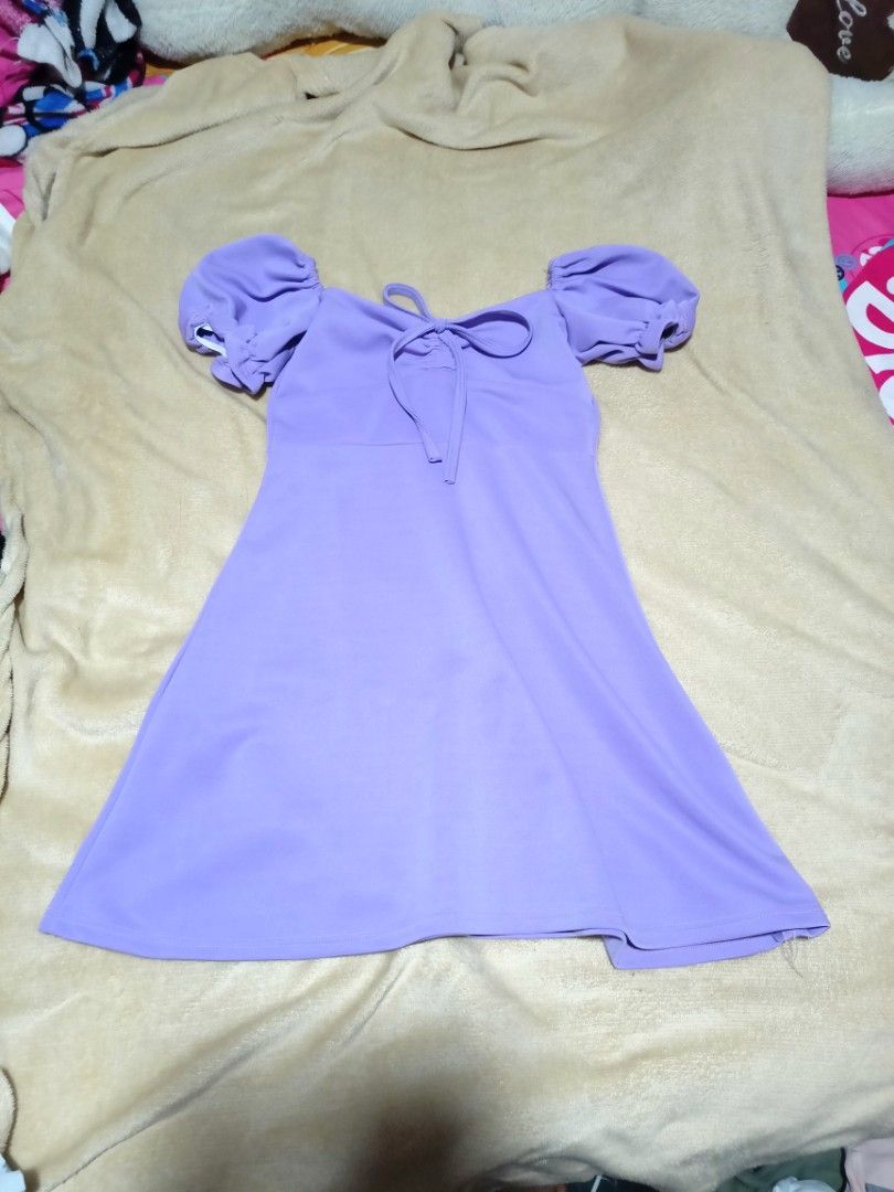 Purple Puff Sleeve Tie Front Mini Dress (Category: Dresses) located in Rizal. Submitted by declutterprod (Listing ID 1440802440, Image 1). Description: - Adorable purple mini dress - Features stylish puff sleeves - Flattering tie-front detail - Made from soft and stretchy fabric for comfort - Please note: there are a couple of small marks on the skirt area. Kindly check the photos for a closer look..