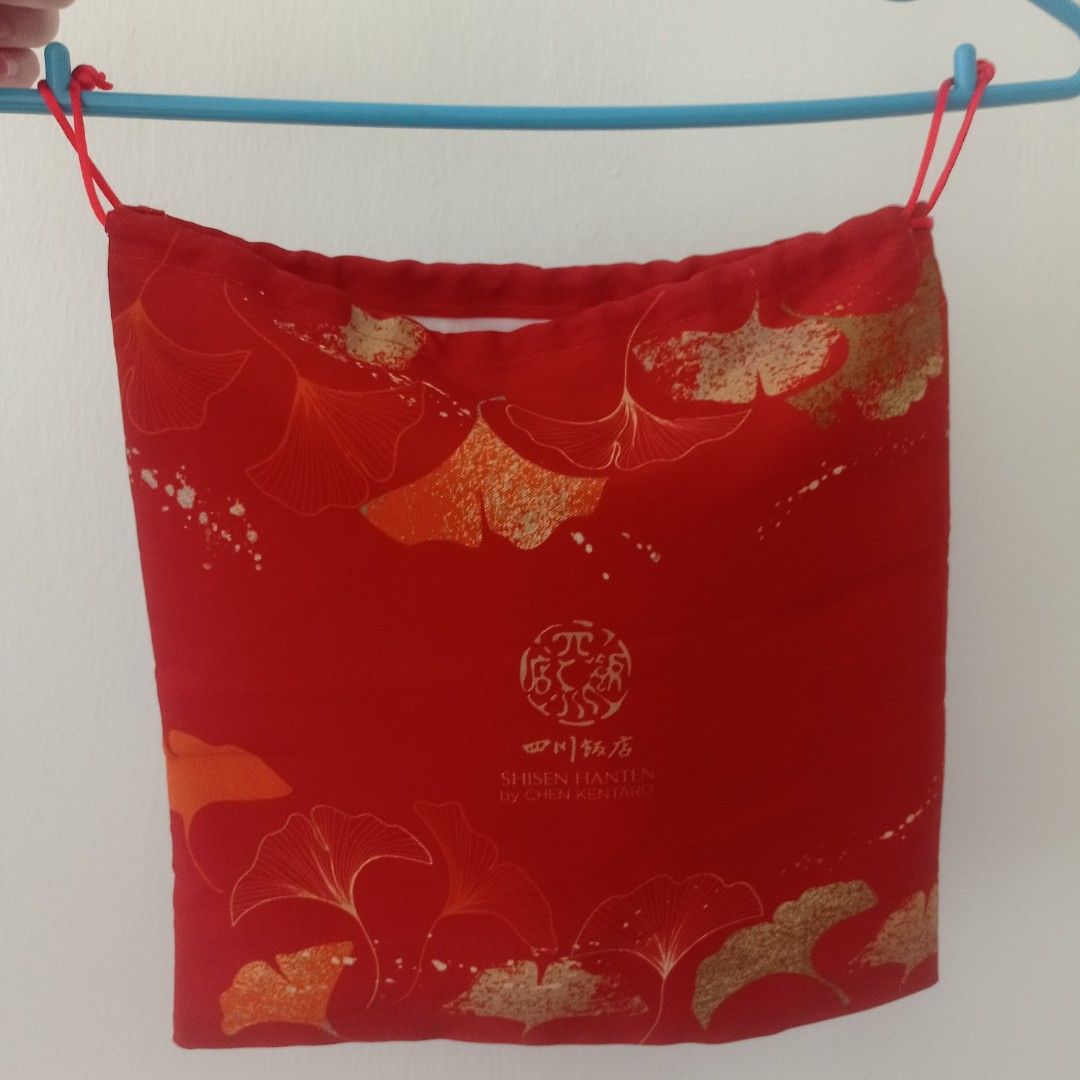 Red Drawstring Pouch with Ginkgo Leaf Design (Category: Home Improvement Tools & Accessories) located in Singapore. Submitted by book14reader (Listing ID 1440828964, Image 1). Description: - Colour: Red - Pattern: Gold Ginkgo Leaf - Closure: Drawstring - Usage: Perfect for storing small items or as a gift bag.