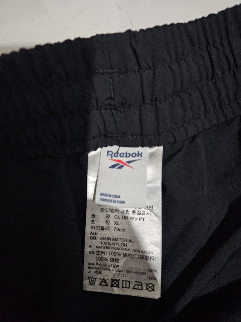 Reebok Black Nylon Track Pants (Category: Joggers) located in Tagum. Submitted by nosfe (Listing ID 1440777956, Image 2). Description: - Black Reebok track pants - 100% Nylon material - Elastic waistband with adjustable drawstring - Size XL - Ideal for sports or casual outings - Comfortable and lightweight design w:32"-36" l:38" h:7".
