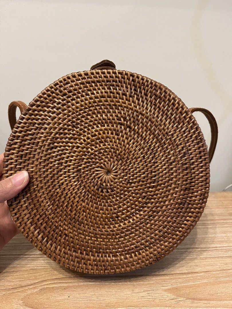 Round Rattan Handmade Bag with Leather Strap (Category: Cross-body Bags) located in Quezon City. Submitted by metamerchant (Listing ID 1440912109, Image 2). Description: - Cute and unique round rattan bag - Made from natural woven material - Features a stylish leather strap and closure - Ideal for beach trips or casual outings - Perfectly sized for your essentials - size: 8.5inches diameter x almost 3inches tall.