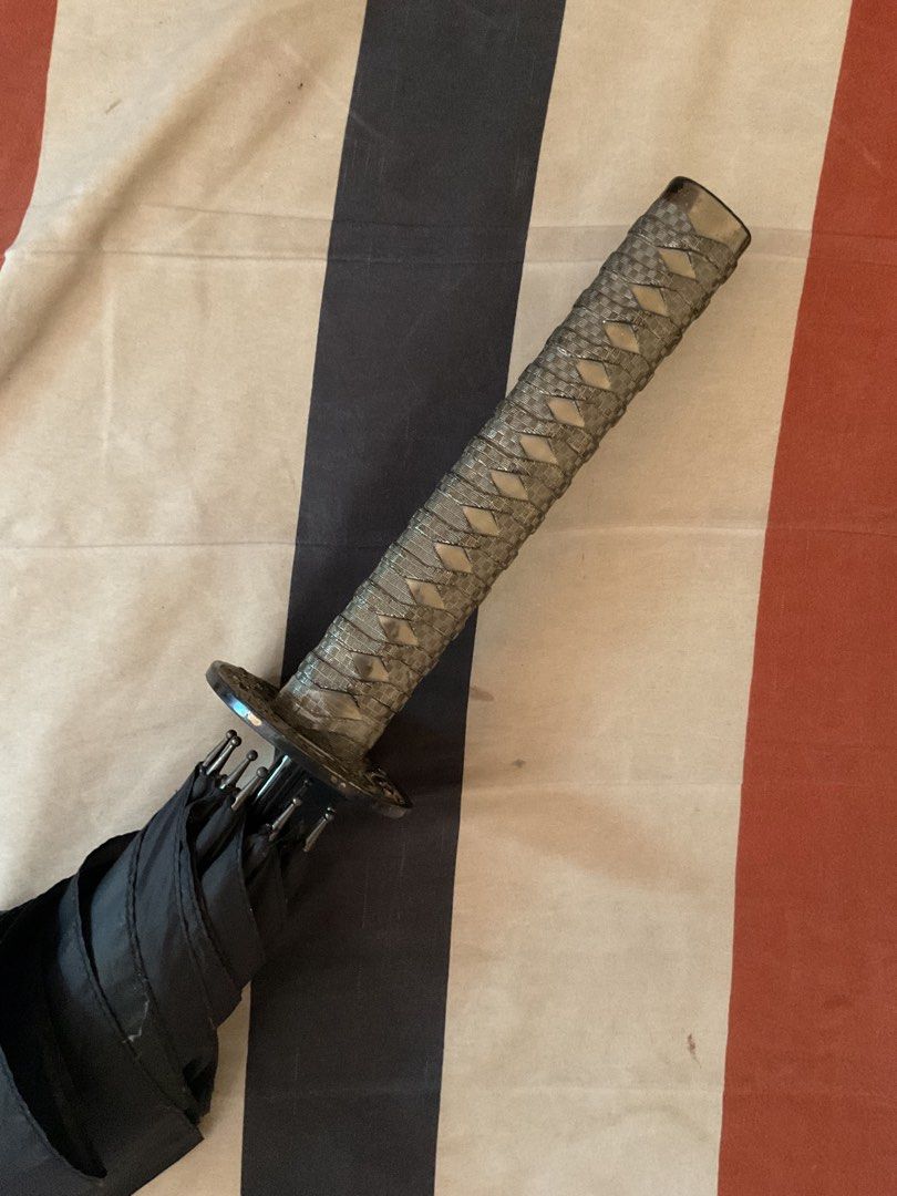 Samurai Sword Handle Umbrella (Category: Umbrellas) located in Naga. Submitted by yosefutofu (Listing ID 1440785887, Image 2). Description: - Cool black umbrella with a unique samurai sword handle. - Realistic and detailed handle design. - Opens and closes just like a regular umbrella. - Great for cosplay, costumes, or as a fun conversation starter. •Samurai Umbrella from Japan. •Free shipping na •Matibay to. High Quality. • Isang Dekada na, di p