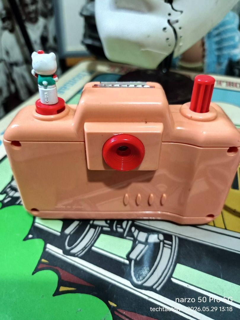Sanrio Puroland Hello Kitty Toy Camera (Category: Cameras) located in Santo Tomas. Submitted by pickers_corner (Listing ID 1440863563, Image 2). Description: vintage Sanrio Puroland toy camera from 1998 featuring characters like Hello Kitty and Badtz-Maru. view finder working very good condition - Adorable pink toy camera from Sanrio Puroland - Features a cute Kitty figure on top - Unique lens with a character inside when viewed - Ideal for colle