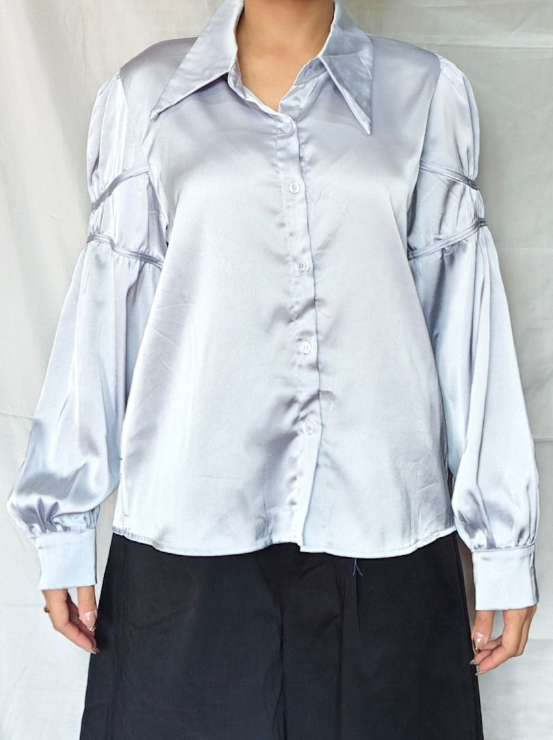 Silver Blue Silk-Feel Collared Button Up | Corporate Chic - Event Wear (Category: Blouses) located in Echague. Submitted by arriettyedit (Listing ID 1440834405, Image 1). Description: Light blue satin shirt. Has a pointed collar and button-up front. Features dramatic puff sleeves with gathered details. Looks great tucked into a skirt or high-waisted pants. Comfortable and stylish for any occasion..