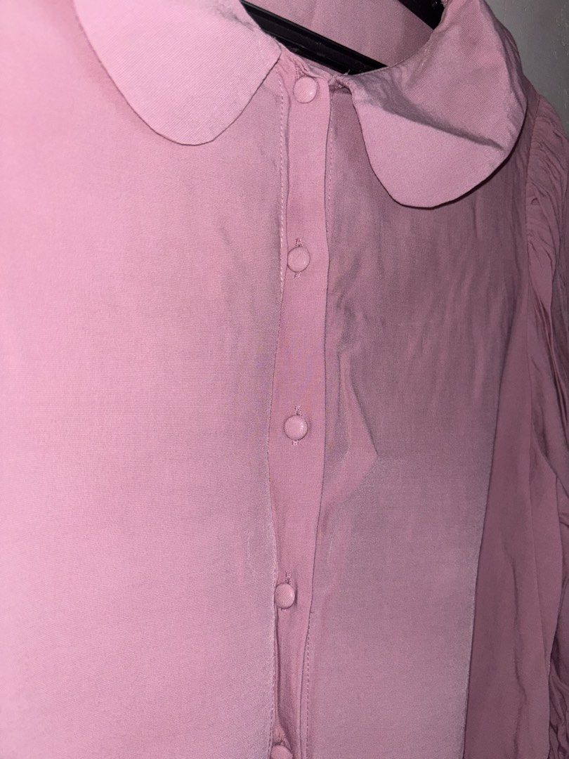 SM Woman Pink Peter Pan Collar Button Up Blouse (Category: Blouses) located in General Trias. Submitted by r_bimil (Listing ID 1440950413, Image 3). Description: - Adorable pink blouse with a charming Peter Pan collar. - Features a classic button-up front. - Slightly puffed sleeves gathered at the cuff for a touch of detail. - Designed for a relaxed, comfortable fit. - Versatile for casual outings or adding a polished touch to your outfit. - Effo