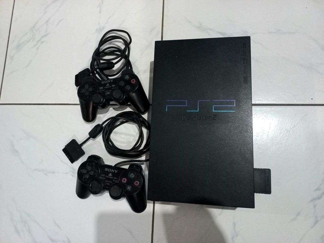 Sony PlayStation 2 PS2 Console with 2 Controllers & Cables (Category: PlayStation) located in Rizal. Submitted by geniustito65 (Listing ID 1440762378, Image 1). Description: - Sony PlayStation 2 Console - Includes 2 Black Controllers - All Necessary Cables Included (Power, AV) - Original.