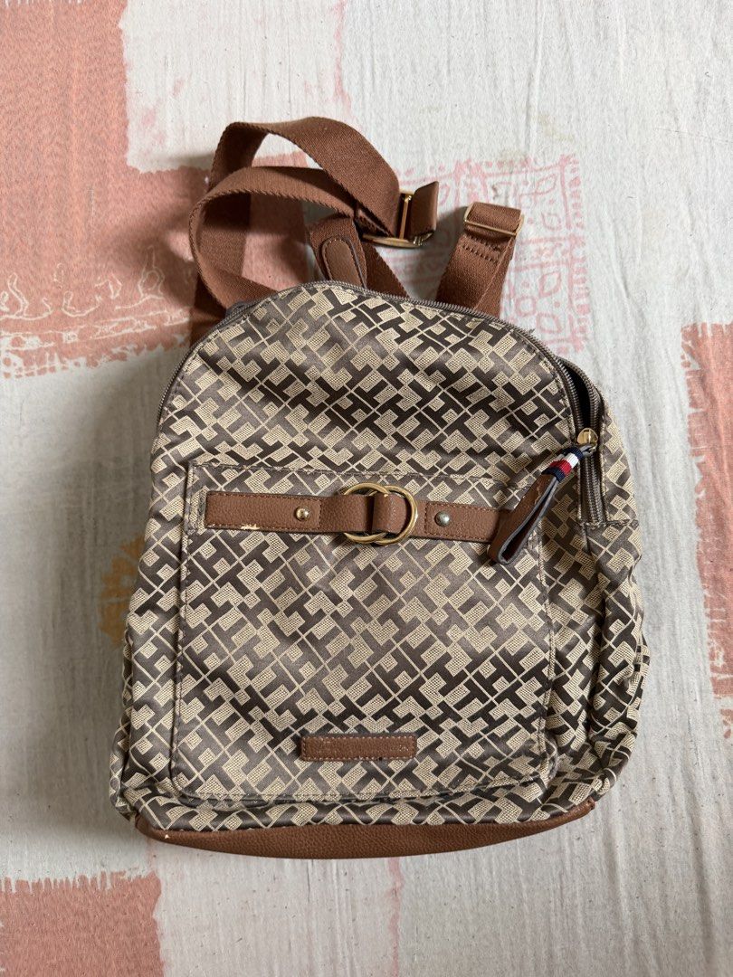Tommy Hilfiger Monogram Canvas Backpack (Category: Backpacks) located in Manila. Submitted by chiechums (Listing ID 1440795361, Image 1). Description: - Authentic Tommy Hilfiger backpack - Classic tan and brown all-over monogram print - Stylish leather trim and strap details - Spacious main compartment with interior zip pocket - Smooth, reliable zippers - Ideal for everyday use, school, or travel.