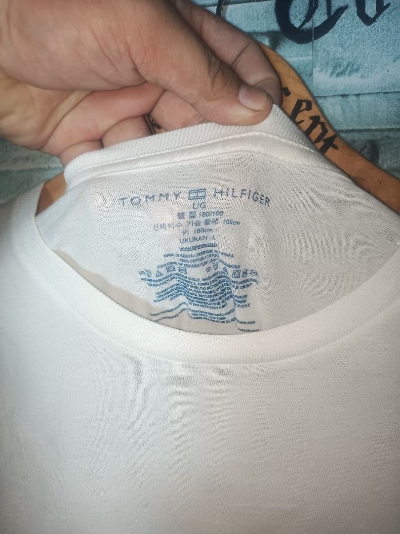 Tommy Hilfiger White T-Shirt (Category: Tshirts & Polo Shirts ) located in Quezon City. Submitted by apconcept22 (Listing ID 1440830248, Image 3). Description: - Classic white Tommy Hilfiger t-shirt - Features the iconic Tommy flag logo on the hem - Size L - Versatile for everyday wear - Easy to pair with any outfit.
