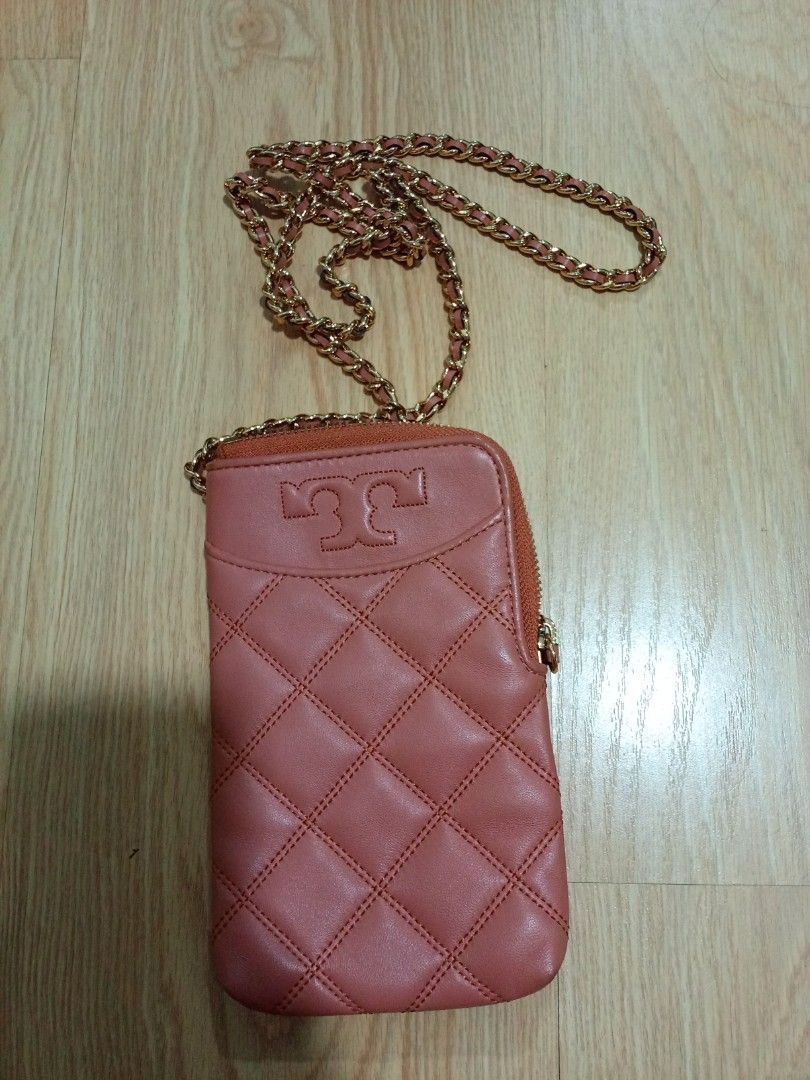Tory Burch Quilted Leather Phone Pouch with Chain (Category: Luxury Bags & Wallets) located in Pasig City. Submitted by matmat1031 (Listing ID 1440854232, Image 1). Description: - Quilted leather phone pouch - Lovely coral shade - Iconic Tory Burch logo - Gold chain strap included - Secure zipper closure - Ideal for phone and a few cards.