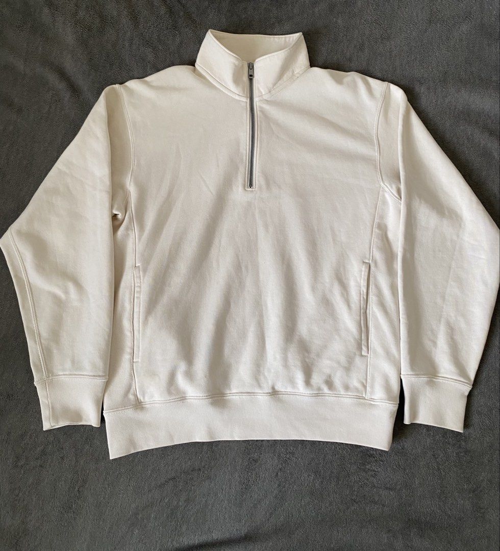Uniqlo Cream Half Zip Sweatshirt (Category: Coats, Jackets and Outerwear) located in Barili. Submitted by macheyzhackiel (Listing ID 1440776693, Image 1). Description: - Cream-colored Uniqlo sweatshirt - Half zip neckline with stand-up collar - Two side pockets - Ribbed cuffs and hem - Made in Vietnam - Material: 80% Cotton, 20% Polyester (Body); 82% Cotton, 18% Polyester (Rib); 100% Cotton (Pocket Lining).