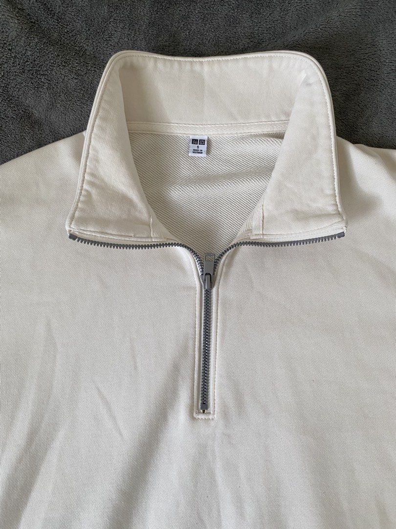 Uniqlo Cream Half Zip Sweatshirt (Category: Coats, Jackets and Outerwear) located in Barili. Submitted by macheyzhackiel (Listing ID 1440776693, Image 2). Description: - Cream-colored Uniqlo sweatshirt - Half zip neckline with stand-up collar - Two side pockets - Ribbed cuffs and hem - Made in Vietnam - Material: 80% Cotton, 20% Polyester (Body); 82% Cotton, 18% Polyester (Rib); 100% Cotton (Pocket Lining).