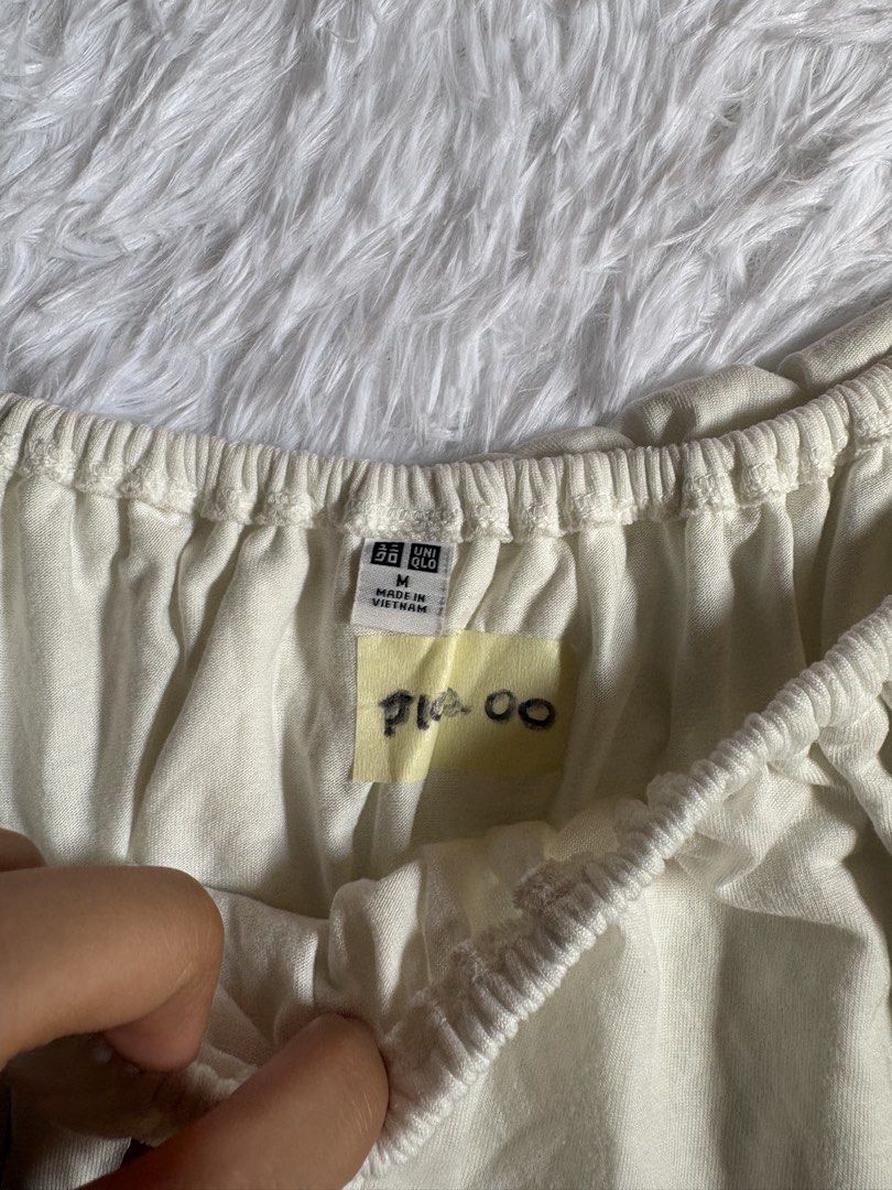 Uniqlo Off-Shoulder Ruffle Top Size M (Category: Blouses) located in Baguio. Submitted by cosmogyralfinds (Listing ID 1440786938, Image 3). Description: - Uniqlo cream off-shoulder top - Size: Medium (M) - Features a ruffle detail across the chest - Elasticated neckline for a comfortable fit - Short sleeves - Easy to style for casual or dressy occasions.
