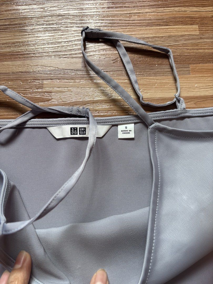 Uniqlo Silver Satin Cami Top Size S (Category: Sleeveless) located in Cordova. Submitted by preloved_branded01 (Listing ID 1440777710, Image 2). Description: - Brand: Uniqlo - Color: Silver - Style: Cami Top - Features: Spaghetti straps, V-neckline - Versatility: Great for layering or wearing solo - Occasion: Suitable for casual and dressy events.