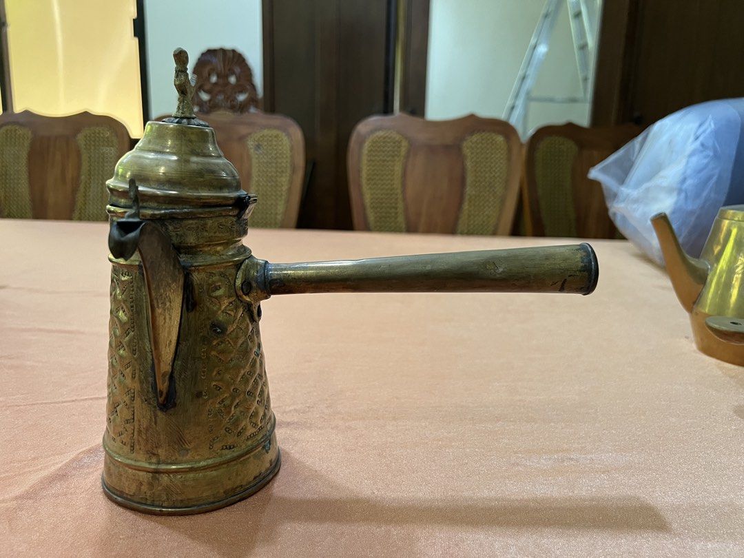 Vintage Brass Coffee Pot with Handle and Lid (Category: Coffee & Tea Tableware) located in Paranaque City. Submitted by mariafernandez917 (Listing ID 1440905205, Image 3). Description: - Antique brass coffee pot - Features intricate patterned detailing all over the body - Long handle for easy handling - Decorative lid with a charming bird finial - Perfect for display or as a unique kitchen accent.