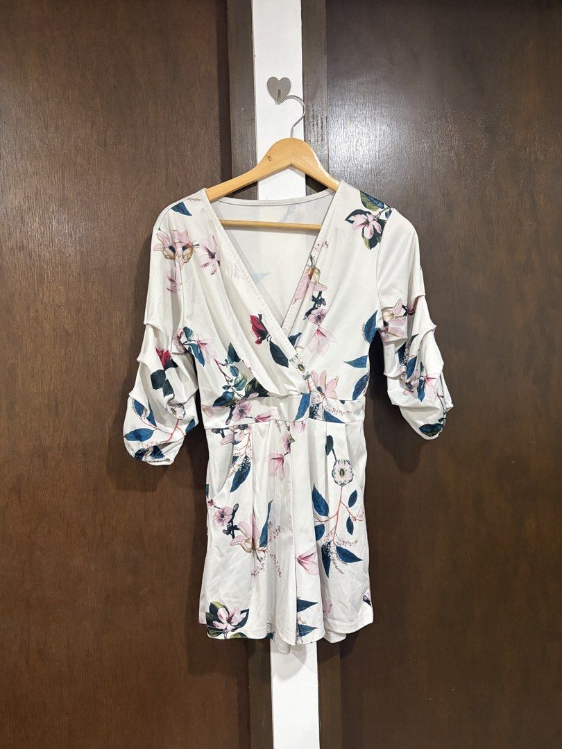 White Floral V-Neck Romper with Ruffled Sleeves (Category: Rompers) located in Makati City. Submitted by jjnsn (Listing ID 1440892213, Image 1). Description: Decluttering!! Chic white floral romper with V-neck wrap, ruffled sleeves, and pockets. .