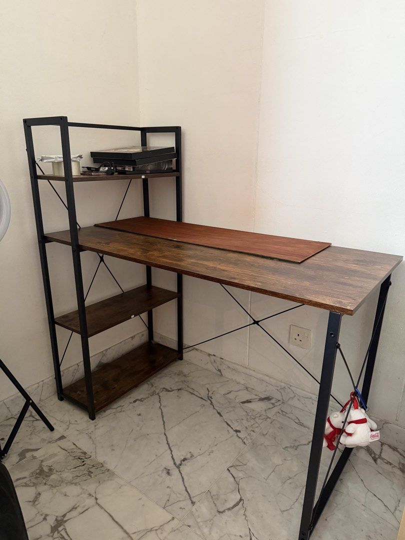 Study Table (Category: Tables & Sets) located in Singapore. Submitted by cxj420 (Listing ID 1440809667, Image 1). Description: - Sturdy desk with integrated shelving unit - Rustic wood grain tabletop finish - Modern industrial metal frame - Ample storage space on shelves - Ideal for home office or study Arrange own transport RFS: Moving Out.