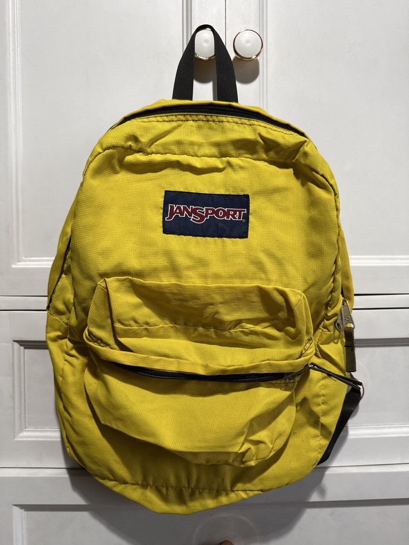 Yellow Jansport Backpack (Category: Backpacks) located in Quezon City. Submitted by itsbiancag (Listing ID 1440863976, Image 1). Description: Classic yellow Jansport backpack. Main compartment and front pocket. Straps are adjustable. Some marks on the back straps, check photos. Good for school or everyday use..