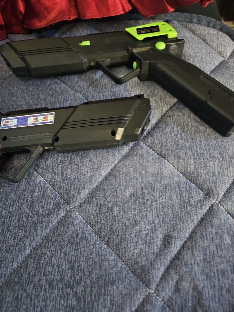 2x Sega Virtual Shooter Lock-On Light Guns (Category: Action & Battle Toys) located in Muntinlupa City. Submitted by jojiepogi123 (Listing ID 1441135193, Image 2). Description: - Set of 2 Sega Saturn Virtual Shooter Lock-On Light Guns - Includes one orange and one green gun - Compatible with Sega Saturn consoles - Ideal for collectors and retro gaming enthusiasts.