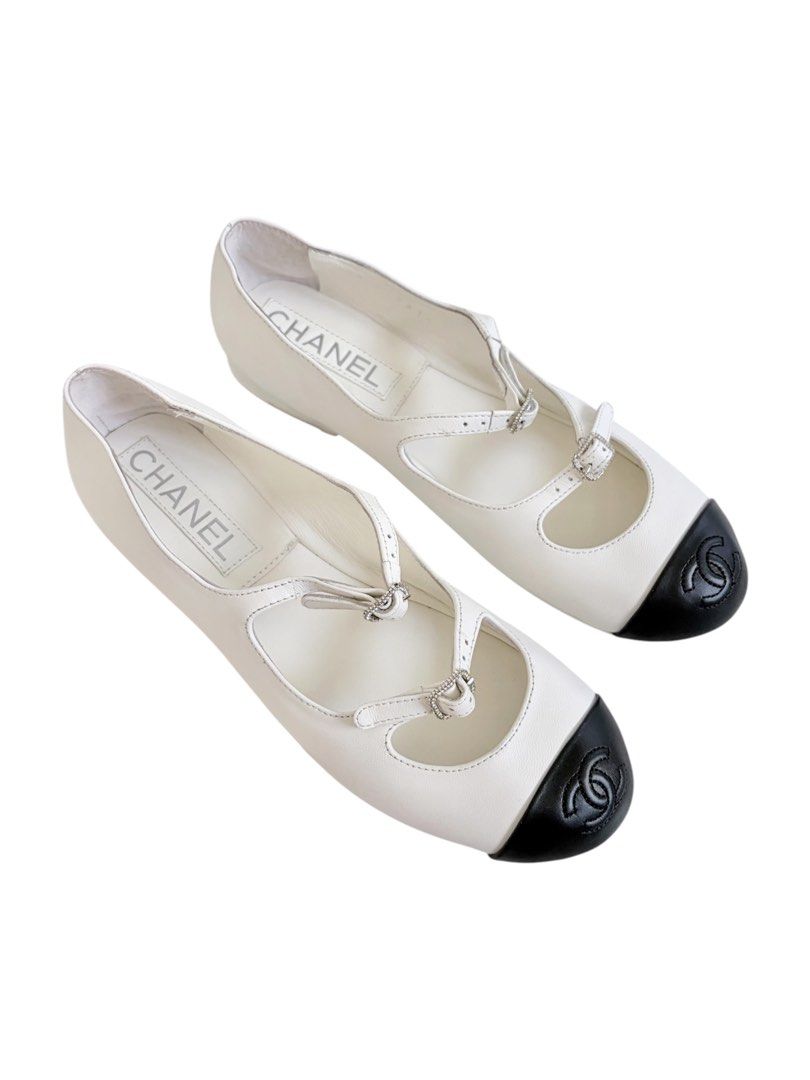 Authentic CHANEL Mary Jane Flats (Category: Sneakers & Footwear) located in Manila. Submitted by serendipitymanila (Listing ID 1441044578, Image 1). Description: - Classic Chanel flats - White leather with black cap toe - Iconic Chanel logo on toe - Adjustable ankle straps with buckle closure - Comfortable and stylish for everyday wear - A great addition to any wardrobe.