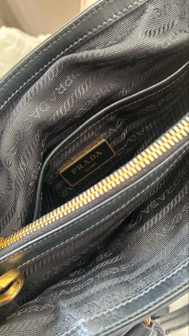 Authentic Prada 2way nylon bag (Category: Luxury Bags & Wallets) located in Quezon City. Submitted by jvll_88 (Listing ID 1441012719, Image 3). Description: - Authentic Prada 2way nylon bag - Black nylon material - Gold-tone hardware - Top handle and detachable shoulder strap - Interior zippered pocket - Protective feet on the bottom - Classic Prada design -dust bag included.