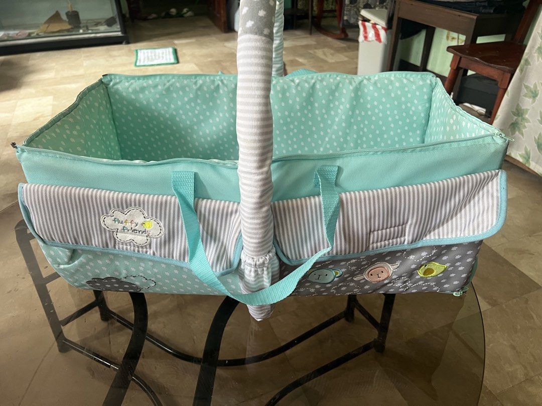 Baby Bassinet with Carry Bag (Category: Cots & Cribs) located in Quezon City. Submitted by charlenedv58782 (Listing ID 1441114591, Image 2). Description: • Soft padded interior for baby’s comfort • Lightweight and portable with carry handles • Foldable design with zipper sides for easy storage • Multiple exterior pockets for baby essentials • Cute mint green, gray, and white pattern • Suitable for newborns and young infants Condition: Gently used