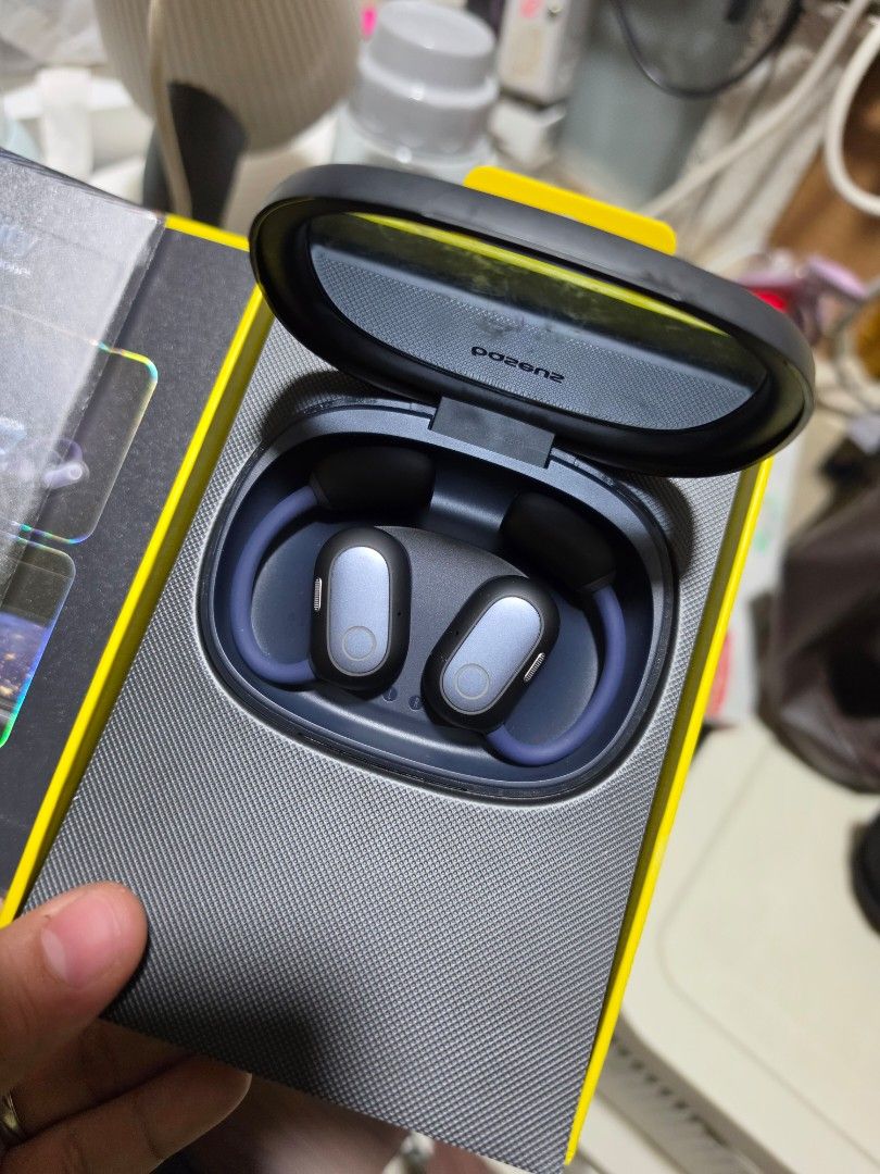 Baseus Eli Fit Open-Ear True Wireless Earphones (Category: Earphones) located in Taguig. Submitted by qqq1795 (Listing ID 1441084838, Image 3). Description: - Baseus Eli Fit Open-Ear True Wireless Earphones - Seamless Bluetooth Connectivity - IPX4 Water Resistance (Sweat & Splash Proof) - Stylish Design: Black Charging Case with Grey & Blue Earbuds - Includes Charging Cable and Quick Start Guide - Ideal for Music & Calls On-the-Go.
