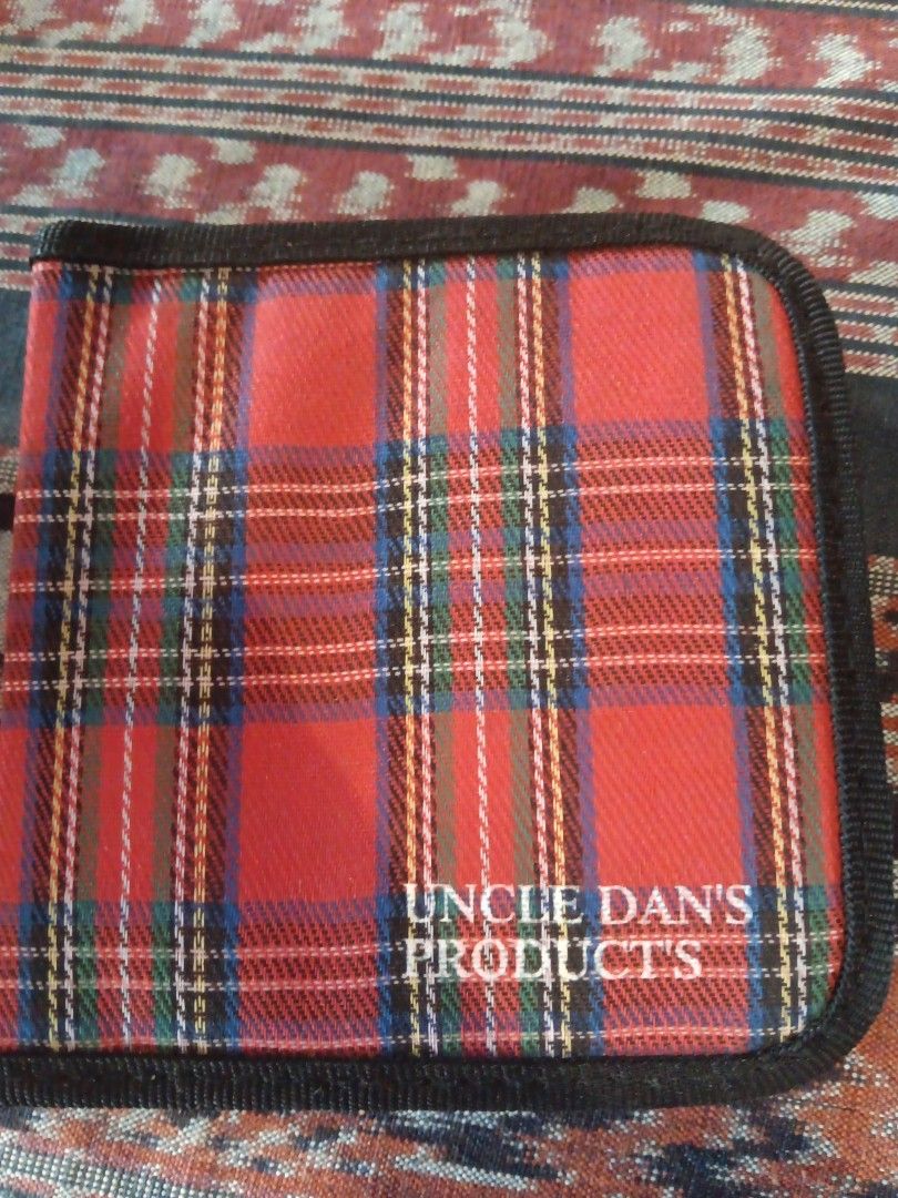 CD Case (Category: CDs & DVDs) located in Sungai Buloh. Submitted by pfoo3 (Listing ID 1441000744, Image 1). Description: - Uncle Dan's Products Plaid CD Case - Zipper closure for secure storage - Ample space for multiple CDs - Ideal for organizing your music collection - Protects discs during travel - Compact and portable design.