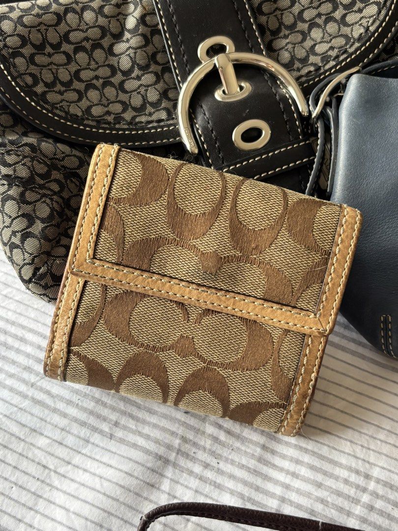 Coach Soho Wallet (Category: Luxury Bags & Wallets) located in Manila. Submitted by mpt99876 (Listing ID 1440994329, Image 2). Description: - Authentic Coach monogram trifold wallet - Color: Brown and tan with tan leather trim - Interior color: Pink - Closure: Secure turn-lock on the front - Features: Ample card slots - Ideal for: Everyday use.