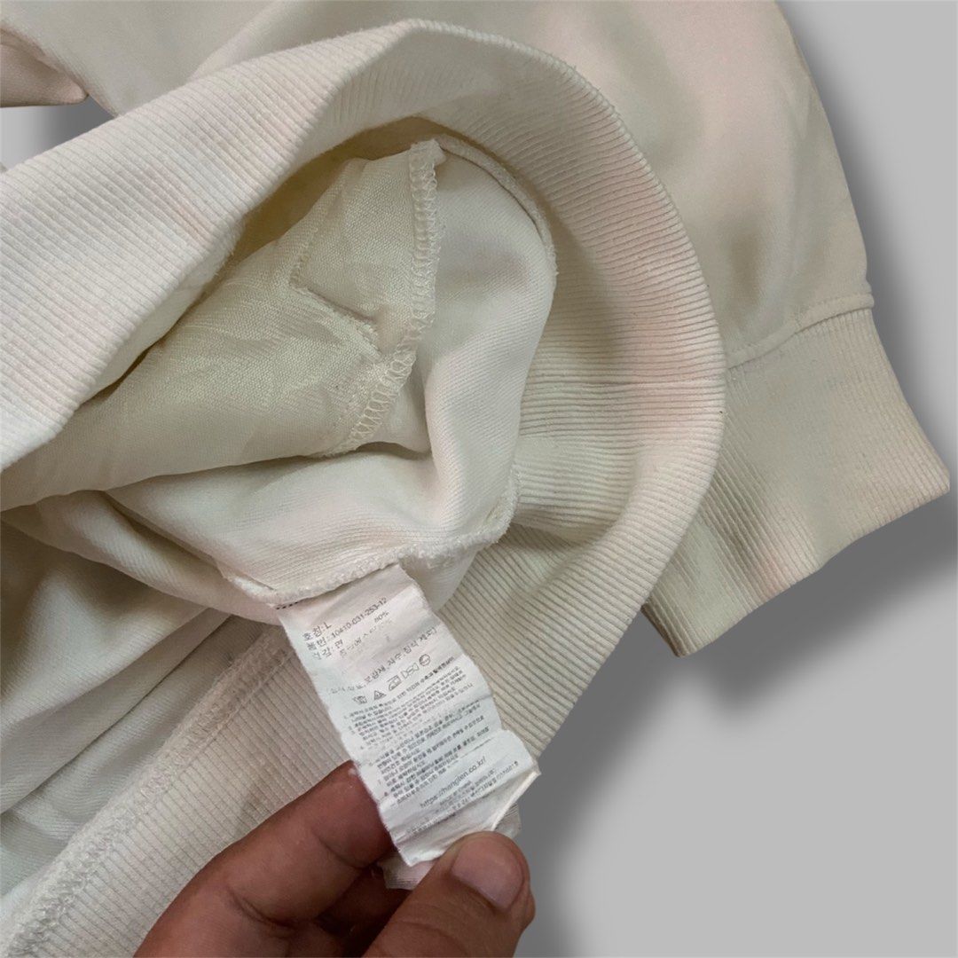 Cream Half Zip Sweatshirt with Embroidered Logo (Category: Coats, Jackets and Outerwear) located in Braulio E. Dujali. Submitted by potchololu39250 (Listing ID 1441078604, Image 3). Description: - Cream colored sweatshirt - Half zip neckline with a collar - Small embroidered logo on the chest - Front kangaroo pocket - Ribbed cuffs and hem - Comfortable and casual style.