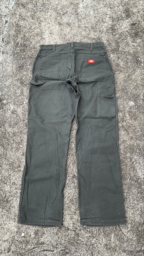 Dickies Carpenter Pants Olive Green (Category: Jeans) located in Jamindan. Submitted by darinville30528 (Listing ID 1441032654, Image 1). Description: - Waistline: 34 - Lenght: 41 - Leg Opening: 8.5 - Classic Dickies carpenter pants - Nice olive green color - Durable workwear style - Multiple pockets for storage - Hammer loop detail - Straight leg fit - Great for everyday wear or work.