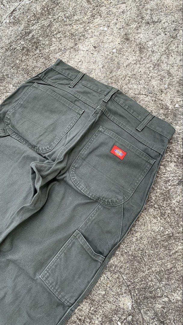 Dickies Carpenter Pants Olive Green (Category: Jeans) located in Jamindan. Submitted by darinville30528 (Listing ID 1441032654, Image 2). Description: - Waistline: 34 - Lenght: 41 - Leg Opening: 8.5 - Classic Dickies carpenter pants - Nice olive green color - Durable workwear style - Multiple pockets for storage - Hammer loop detail - Straight leg fit - Great for everyday wear or work.