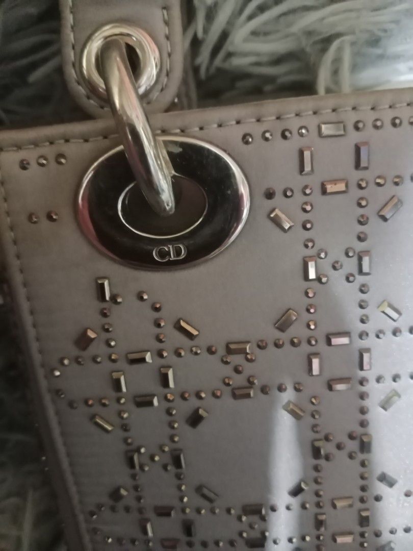 Dior Lady Dior Bag (Category: Luxury Bags & Wallets) located in Zamboanga. Submitted by swiftfish-082e (Listing ID 1441027357, Image 3). Description: - Authentic Dior Lady Dior Handbag - Color: Light Grey - Design: Intricate cut-out pattern with embellishments - Hardware: Silver-toned - Features: Detachable shoulder strap, interior zippered pocket - Condition: Classic, timeless piece.
