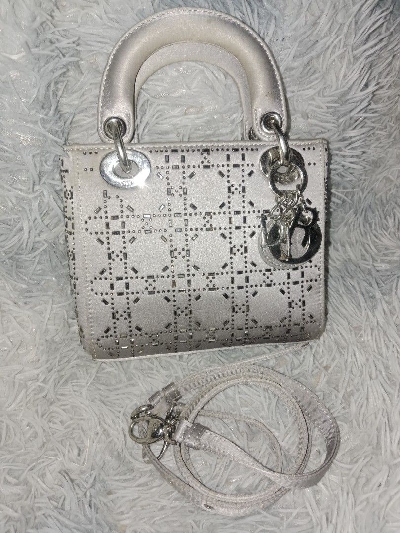 Dior Lady Dior Bag (Category: Luxury Bags & Wallets) located in Zamboanga. Submitted by swiftfish-082e (Listing ID 1441027357, Image 1). Description: - Authentic Dior Lady Dior Handbag - Color: Light Grey - Design: Intricate cut-out pattern with embellishments - Hardware: Silver-toned - Features: Detachable shoulder strap, interior zippered pocket - Condition: Classic, timeless piece.