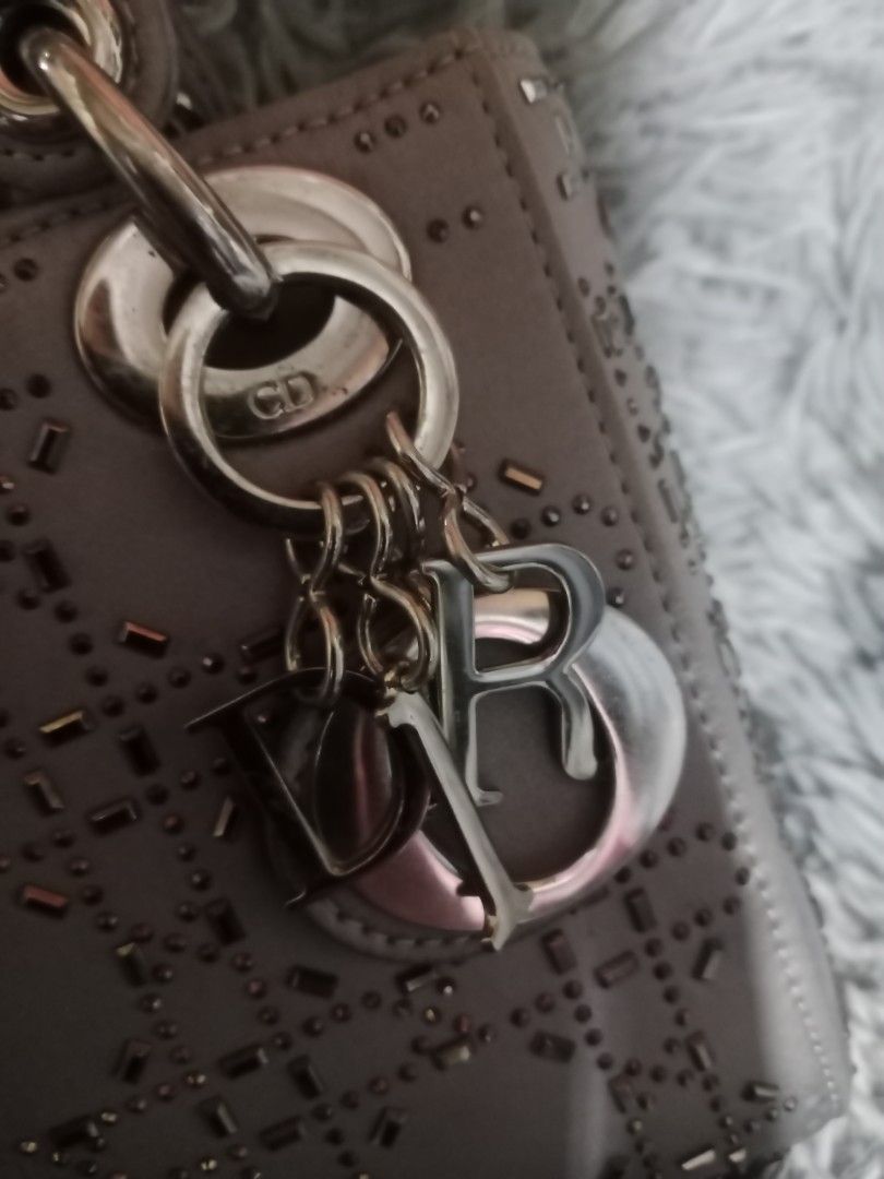 Dior Lady Dior Bag (Category: Luxury Bags & Wallets) located in Zamboanga. Submitted by swiftfish-082e (Listing ID 1441027357, Image 2). Description: - Authentic Dior Lady Dior Handbag - Color: Light Grey - Design: Intricate cut-out pattern with embellishments - Hardware: Silver-toned - Features: Detachable shoulder strap, interior zippered pocket - Condition: Classic, timeless piece.