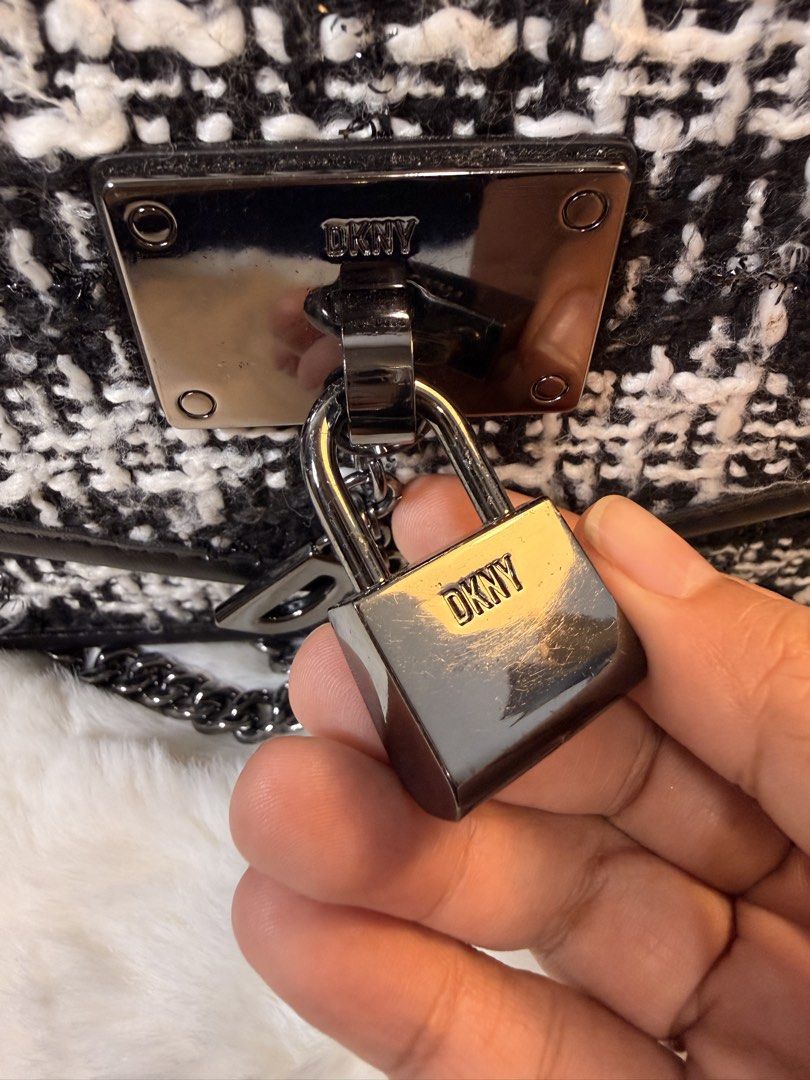 DKNY Tweed Flap Bag with Lock Charm (Category: Luxury Bags & Wallets) located in Dasmarinas. Submitted by gemini_things (Listing ID 1441029379, Image 2). Description: Selling my sophisticated DKNY bag - Stylish black and white tweed flap bag - Features a metal lock charm with DKNY logo - Interior lining with DKNY branding - Made in Indonesia - Includes a chain strap - Versatile for night outs or everyday wear - Can be used as shoulder or crossbdy