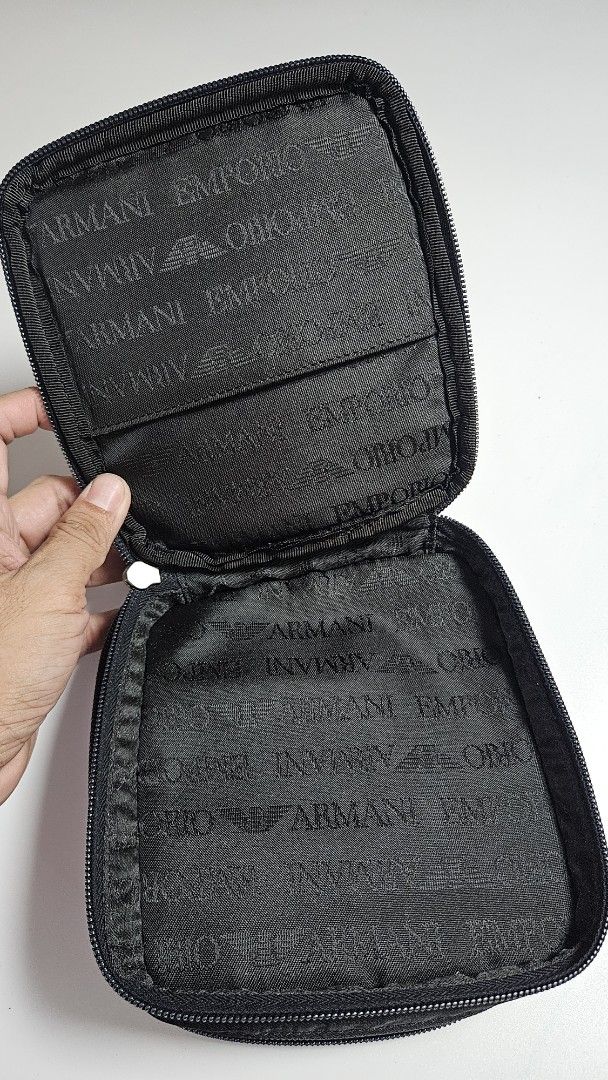 Emporio Armani Black Nylon Pouch (Category: Luxury Bags & Wallets) located in Alfonso. Submitted by jbcamet (Listing ID 1441036811, Image 3). Description: - Authentic Emporio Armani pouch - Made of durable nylon material - Secure zippered closure - Interior features multiple card slots for organization - Compact and easy to carry - Signature Emporio Armani logo pattern inside.