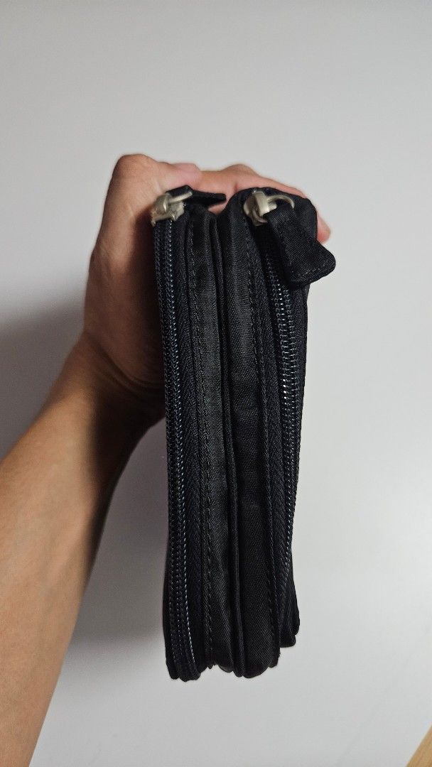 Emporio Armani Black Nylon Pouch (Category: Luxury Bags & Wallets) located in Alfonso. Submitted by jbcamet (Listing ID 1441036811, Image 2). Description: - Authentic Emporio Armani pouch - Made of durable nylon material - Secure zippered closure - Interior features multiple card slots for organization - Compact and easy to carry - Signature Emporio Armani logo pattern inside.