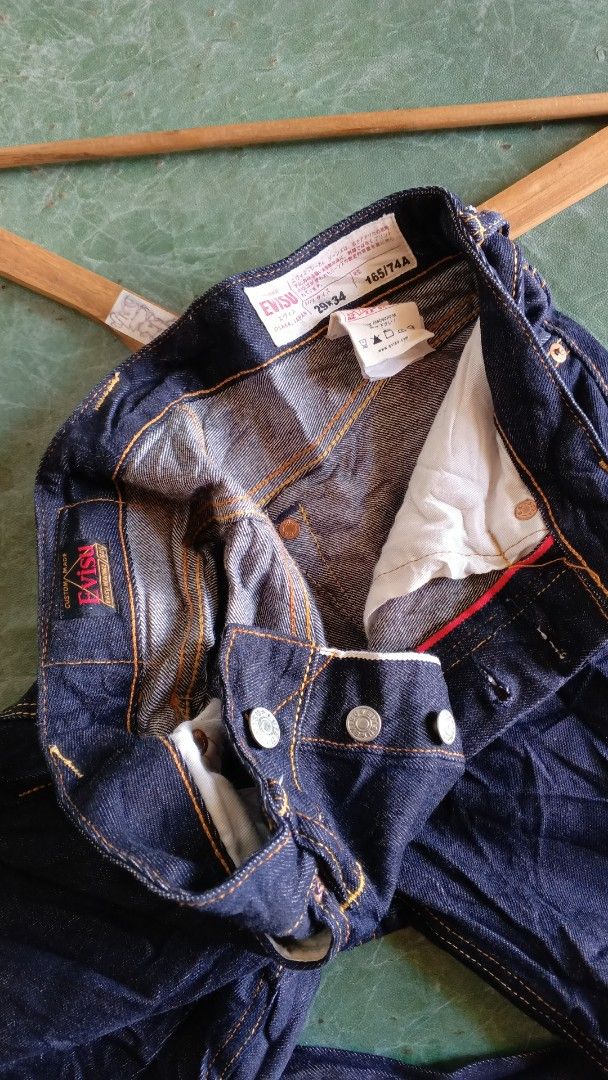 EVISU Jeans Dragon Embroidery Size 29 (Category: Jeans) located in Cateel. Submitted by tsedrickra31083 (Listing ID 1441095391, Image 3). Description: - Dark wash EVISU jeans - Size 30 waist - Large dragon and wave embroidery on back - Orange contrast stitching throughout - Button fly closure - Ideal for streetwear enthusiasts.