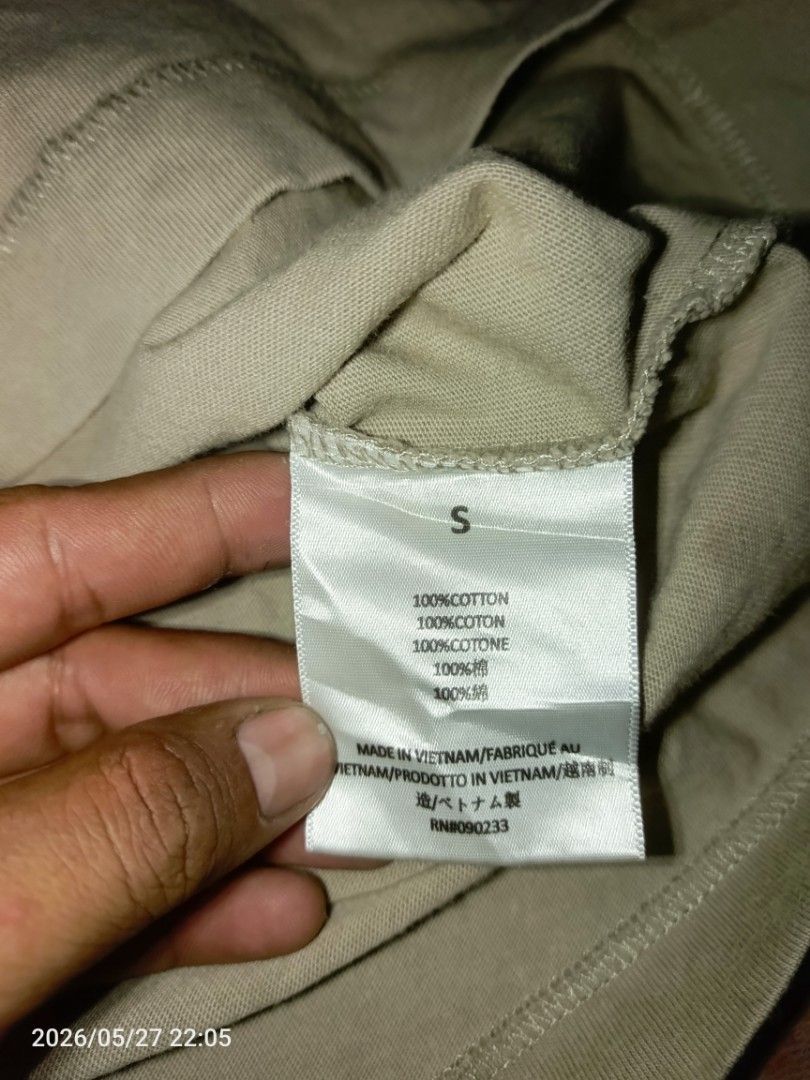 Fear of God Essentials Beige V-Neck T-Shirt Size S (Category: Tshirts & Polo Shirts ) located in Caloocan City. Submitted by vincefresn21903 (Listing ID 1440954546, Image 2). Description: - Brand: Essentials - Color: Beige - Neckline: V-neck - Material: 100% Cotton - Fit: Boxy Fit - Features: Tie detail at hem - Size: Tagged Small best fit to XL - Style: Versatile staple piece - Excellent Condition.