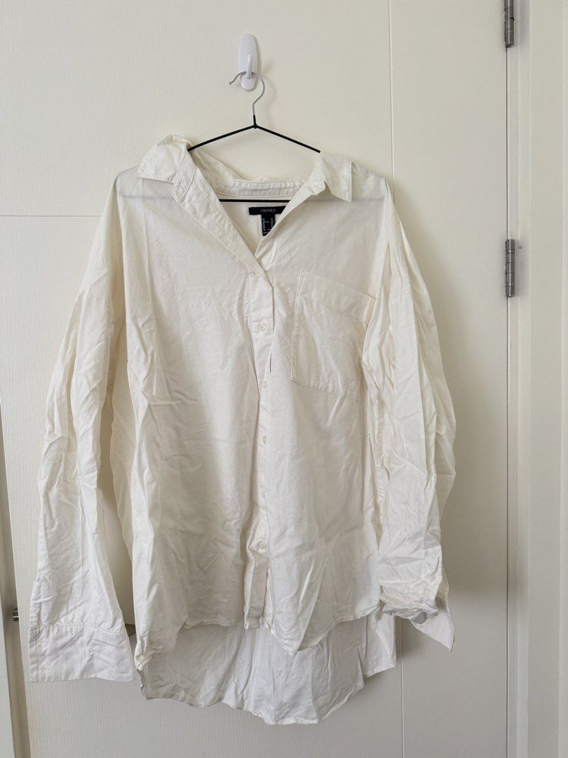 Forever 21 White Oversized Button-Up Shirt XL (Category: Shirts) located in Mandaluyong City. Submitted by trinket.ph (Listing ID 1440964670, Image 1). Description: - Off White oversized button-up shirt - Brand: Forever 21 - Size: XL (Relaxed fit) - Ideal for layering or wearing on its own - Easy to style for casual or smart-casual looks - Please check photos for exact shade and details.