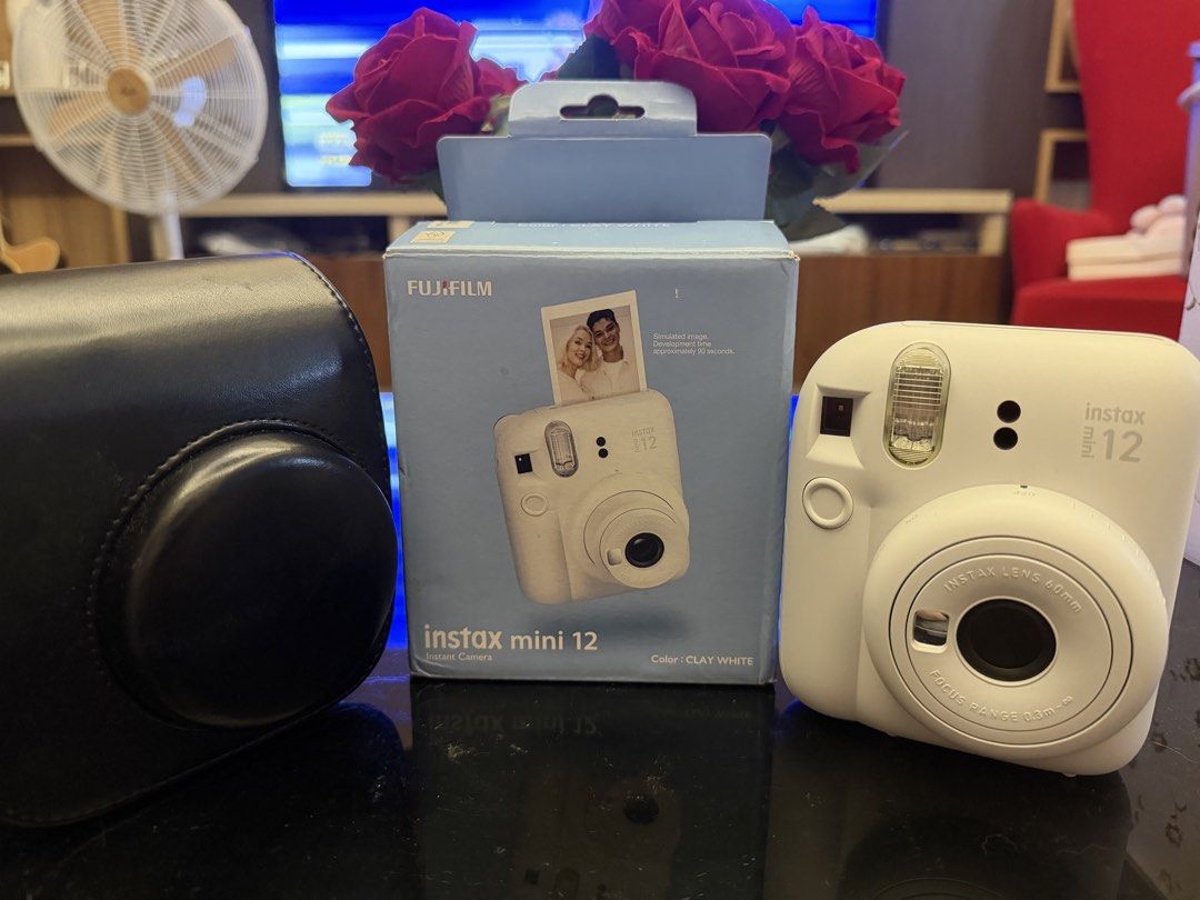 Fujifilm Instax Mini 12 Instant Camera - Clay White (Category: Cameras) located in Taguig. Submitted by crsthngs (Listing ID 1441098531, Image 1). Description: - Fujifilm Instax Mini 12 Camera - Color: Clay White - Includes original box - Comes with a black camera case - With 7 Films inside.