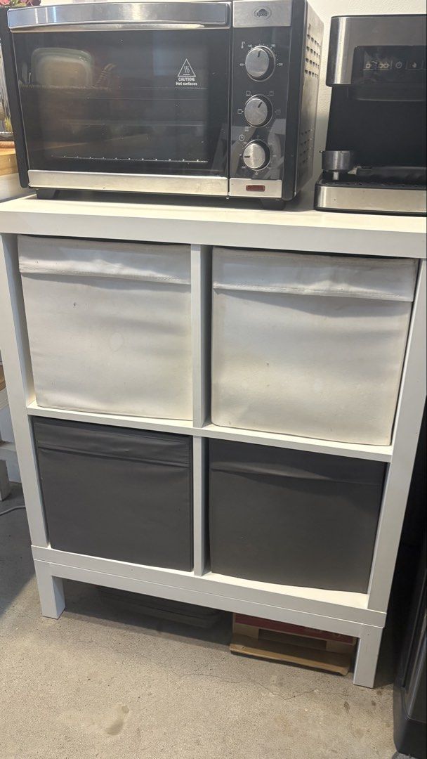 IKEA KALLAX 4-Cube Shelf Unit with Storage Bins (Category: Shelves, Cabinets & Racks) located in Mandaluyong City. Submitted by anjie52 (Listing ID 1440992174, Image 3). Description: - White IKEA KALLAX shelf unit - cube compartments not included - Ideal for organizing books, toys, and more - Top surface suitable for small appliances unit is sturdy and functional Can be bundled with espresso machine for total of 4300.