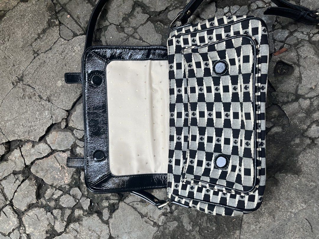 Kate Spade Black & White Checkerboard Shoulder Bag (Category: Shoulder Bags) located in Muntinlupa City. Submitted by cutiepie143 (Listing ID 1441067698, Image 3). Description: - Cute Kate Spade shoulder bag - Classic black and white checkerboard pattern - Stylish patent leather trim and strap - Spade details throughout - Front flap with decorative buckle - Interior includes a zip pocket and slip pockets - Ideal for everyday use and adding a touc