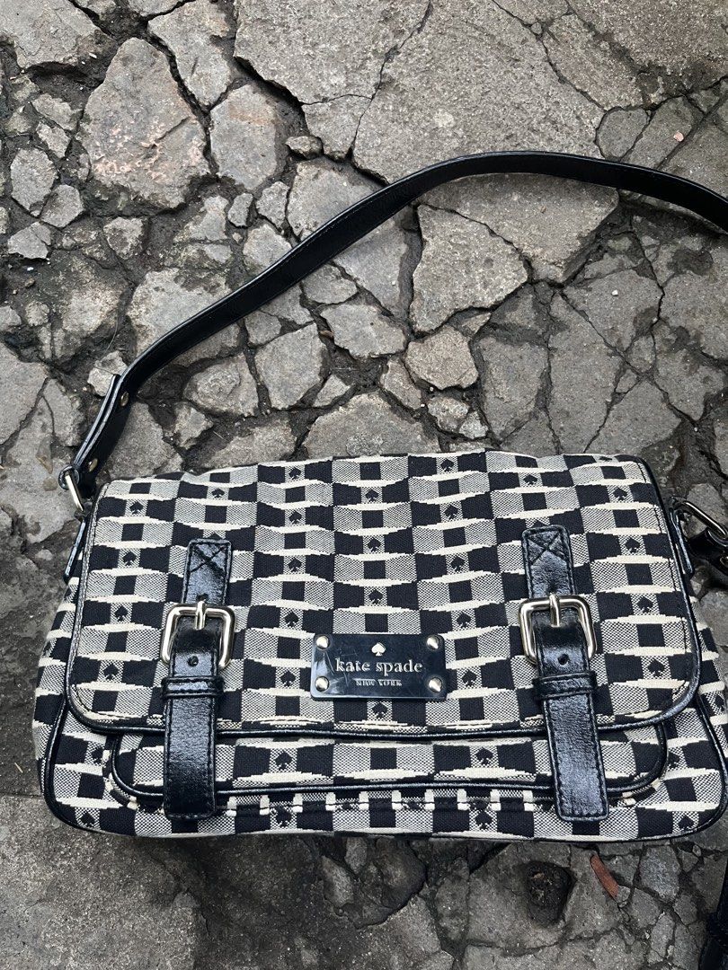 Kate Spade Black & White Checkerboard Shoulder Bag (Category: Shoulder Bags) located in Muntinlupa City. Submitted by cutiepie143 (Listing ID 1441067698, Image 2). Description: - Cute Kate Spade shoulder bag - Classic black and white checkerboard pattern - Stylish patent leather trim and strap - Spade details throughout - Front flap with decorative buckle - Interior includes a zip pocket and slip pockets - Ideal for everyday use and adding a touc