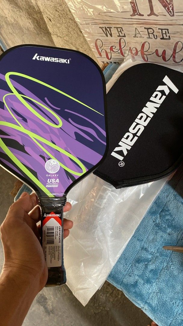 Kawasaki Pickleball Paddle with Cover (Category: Racket and Ball Sports) located in Taguig. Submitted by jerafelsan87737 (Listing ID 1441053629, Image 1). Description: - Brand New Kawasaki Pickleball Paddle - Eye-catching Purple and Green Design - Comes with a Protective Black Kawasaki Cover - Perfect for Enjoying the Game of Pickleball - Feel free to message me with any questions!.