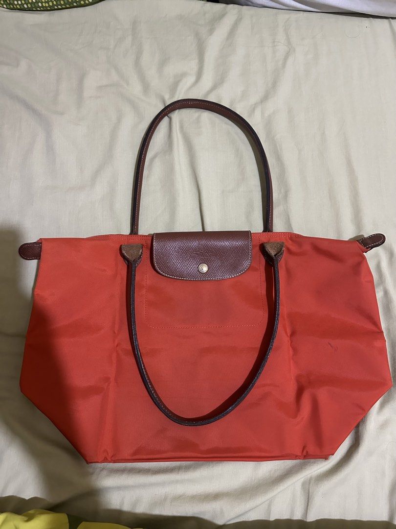 Longchamp Le Pliage Tote Bag orange (Category: Luxury Bags & Wallets) located in Rizal. Submitted by colosas (Listing ID 1441027483, Image 2). Description: Classic Longchamp tote in bright red. Features leather handles/trim, folds flat. Perfect for daily use or travel, with ample space. A timeless accessory..