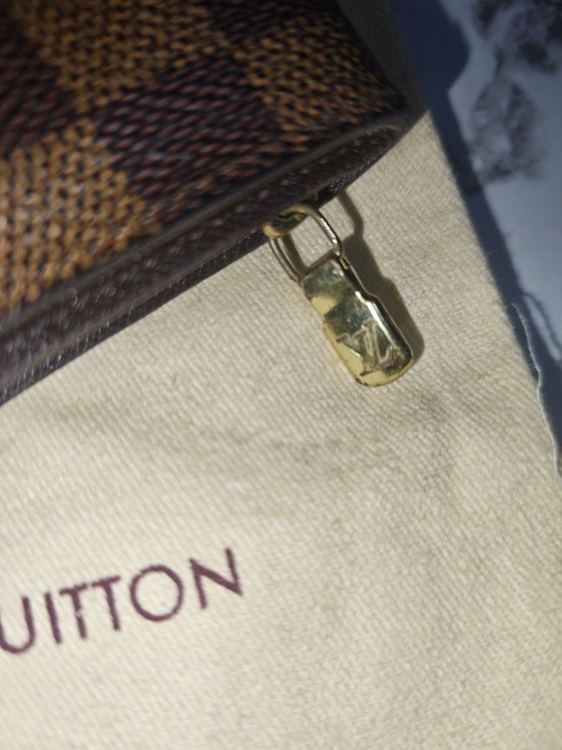 Louis Vuitton Damier Ebene Canvas Wallet (Category: Luxury Bags & Wallets) located in Zamboanga. Submitted by gothicstyle_etc (Listing ID 1441070049, Image 3). Description: - Authentic Louis Vuitton Wallet - Damier Ebene Canvas with Brown Leather Trim - Snap Button Closure - Gold-Tone Hardware with LV Logo - Interior Card Slots and Coin Pocket - Includes Original Dust Bag - Date Code: CA0051.