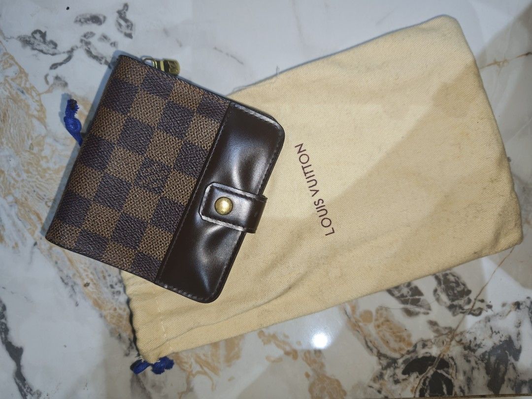 Louis Vuitton Damier Ebene Canvas Wallet (Category: Luxury Bags & Wallets) located in Zamboanga. Submitted by gothicstyle_etc (Listing ID 1441070049, Image 2). Description: - Authentic Louis Vuitton Wallet - Damier Ebene Canvas with Brown Leather Trim - Snap Button Closure - Gold-Tone Hardware with LV Logo - Interior Card Slots and Coin Pocket - Includes Original Dust Bag - Date Code: CA0051.