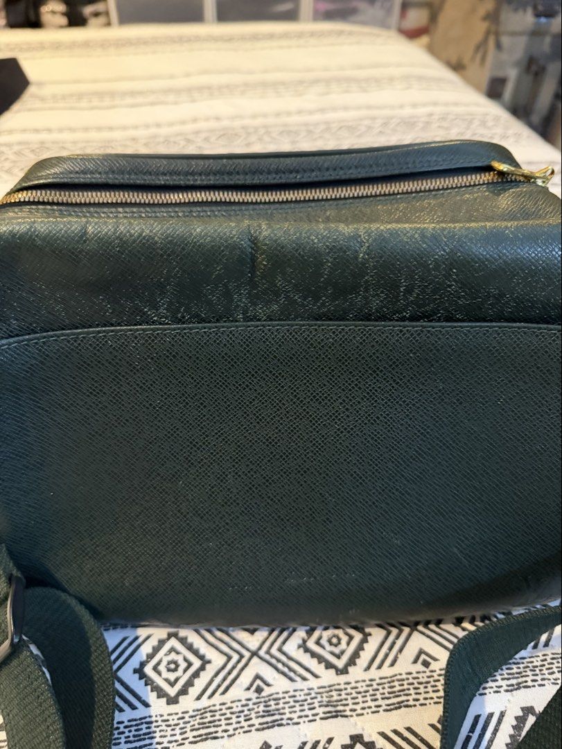 LV Taiga Leather Messenger Bag (Category: Luxury Bags & Wallets) located in San Juan City. Submitted by jeni4 (Listing ID 1441047761, Image 2). Description: Dark/deep green color Scratches in front/top of pocket and a few at the back .