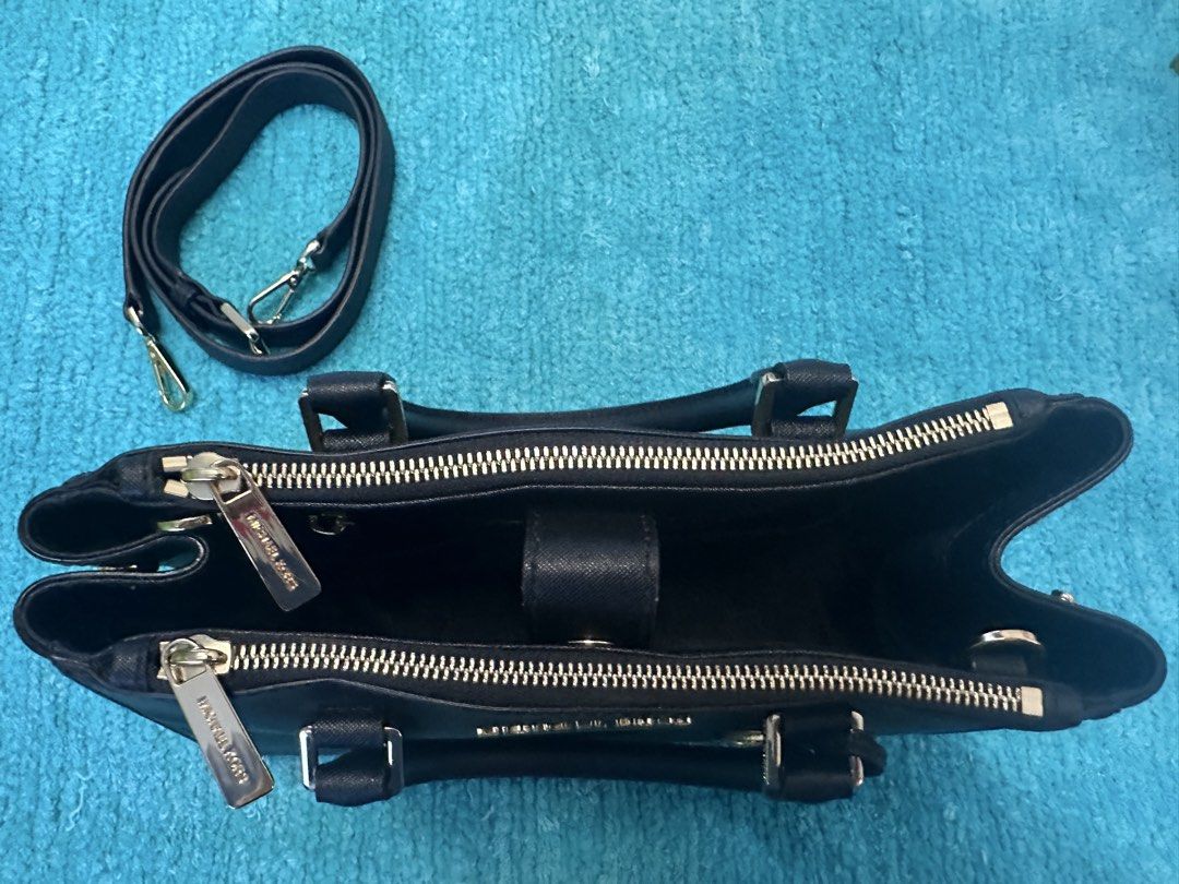 Michael Kors Sutton Black Leather Satchel Handbag (Category: Luxury Bags & Wallets) located in Las Pinas. Submitted by mickey0901 (Listing ID 1441008487, Image 3). Description: - Genuine black leather Michael Kors satchel - Elegant gold hardware details - Versatile carrying options: top handles and detachable crossbody strap - Organized interior with multiple compartments and zip closures - Iconic Michael Kors charm included - Ideal for both dail
